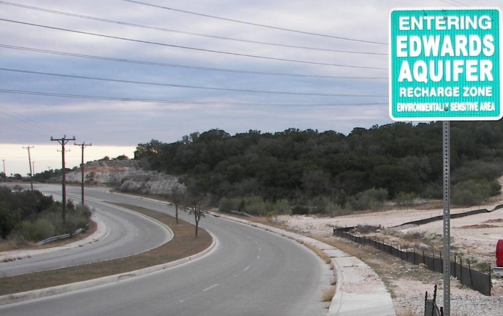 Entering Edwards Aquifer Recharge Zone roadside sign along a winding road