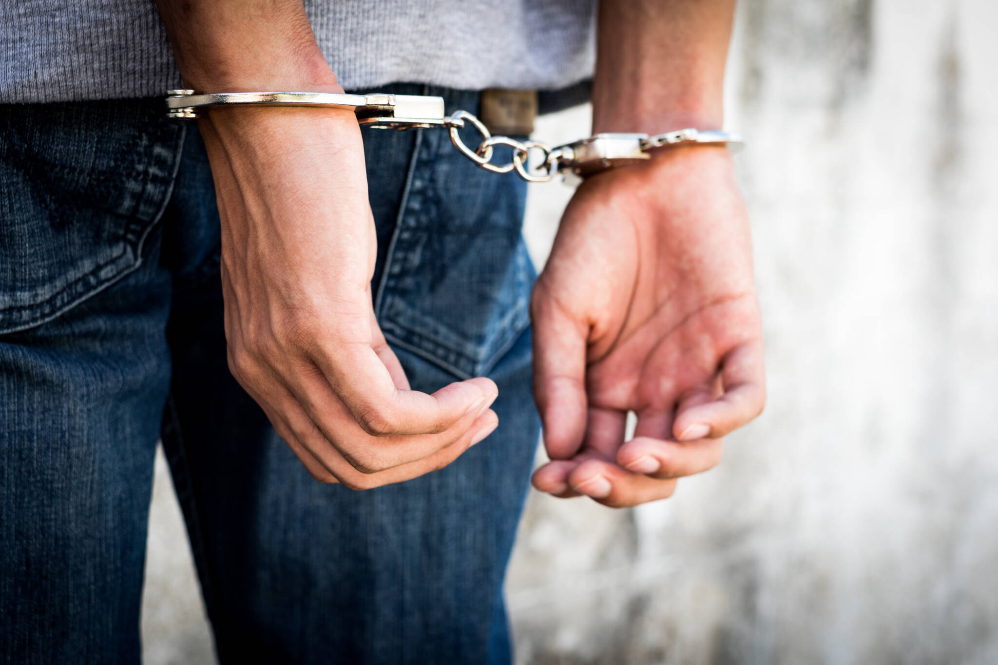 Close Up Hands Tied Up Handcuffs In Behind His Body. Arrested Ma